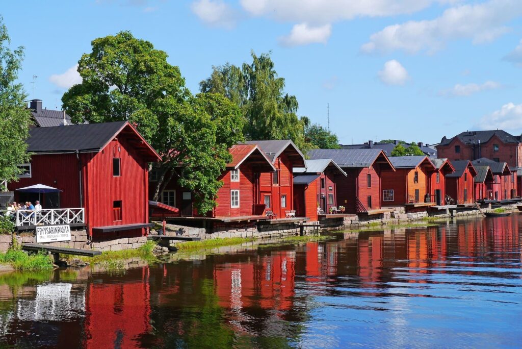 Red wooden riverside houses in Porvoo on a private tour from Helsinki