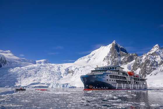 Expedition cruise ship in a snowy fjord