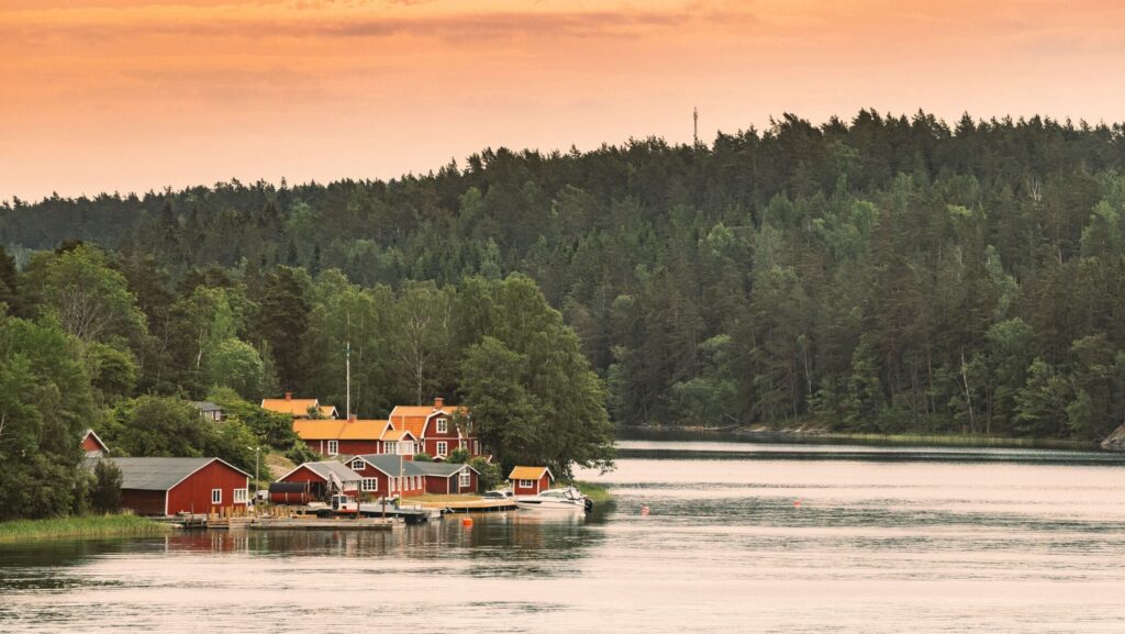 Red wooden cabins in a Nordic landscape on a Finland and Sweden journey via Lapland