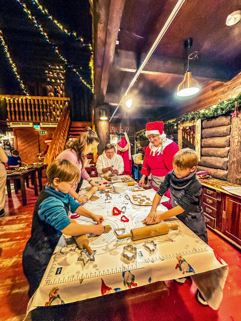 Children and adults decorating gingerbread during a Christmas workshop